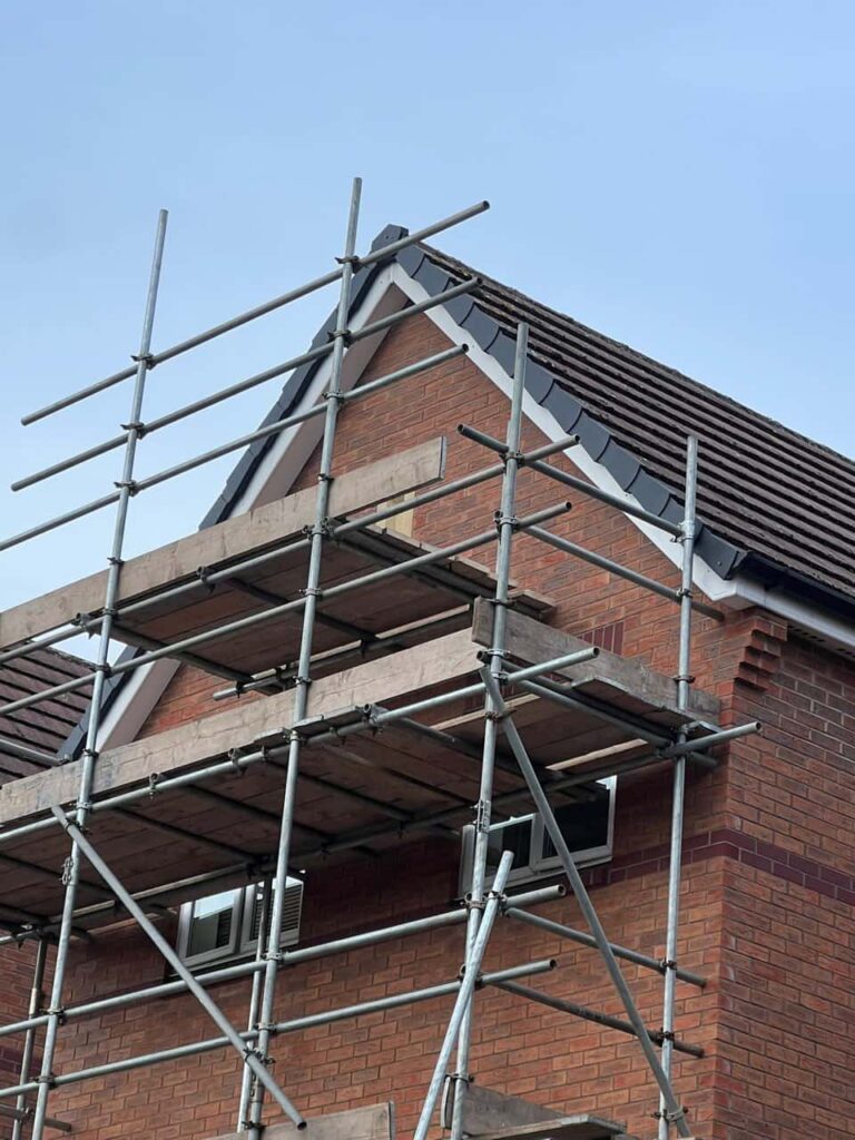This is a photo of a roof which has just been repaired. There is a scaffold located at the gable end for access onto the roof. Works carried out by Hayling Island Roofing Repairs