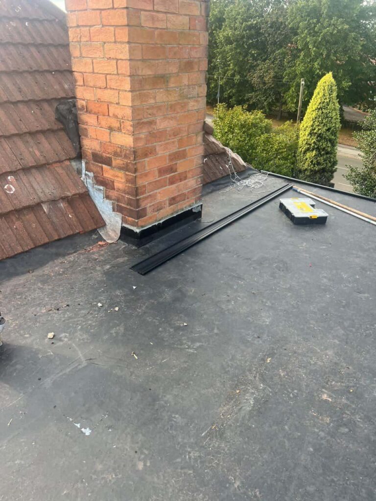 This is a photo of a flat roof which has just been repaired, there is also a chimney stack and some leadwork has also been dressed. Works carried out by Hayling Island Roofing Repairs